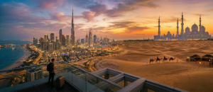 Dubai skyline with Burj Khalifa and desert safari with camels at sunset